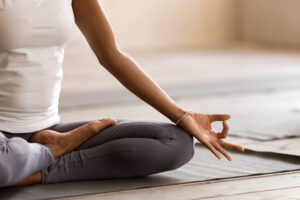 a woman meditating and practicing yoga and mindfulness